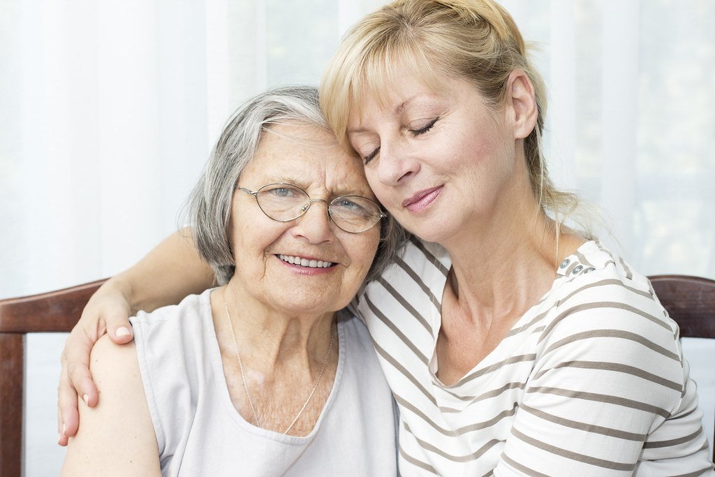Senior woman and her daughter sharing a hug